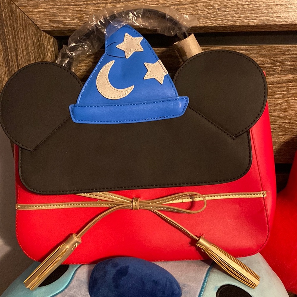 Fantasia Mickey Mouse crossbody. Has small dents on front and back.